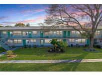 Charming condo building with well-maintained lawns, mature trees and walkways at 5850 21St N St # 12, St Petersburg, FL 33714