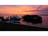 Waterfront property with private dock, boat, and stunning sunset views at 684 Regatta Way, Bradenton, FL 34208