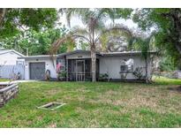 Charming single-story home with a well-maintained lawn and a mature palm tree in the front yard at 809 S Palm Dr, Largo, FL 33770