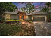 Charming single-story home with landscaped front yard, brick accents, and attached two car garage at 2997 Eagle Estates E Cir, Clearwater, FL 33761