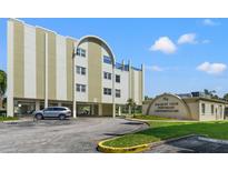 Beautiful exterior of Racquet Club Northeast Condominiums with covered parking and manicured landscaping at 4681 1St Ne St # 306, St Petersburg, FL 33703