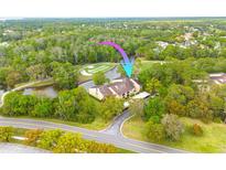 Beautiful condo aerial view featuring a well-maintained exterior, lush landscaping, and golf course views at 50 St Andrews Pl # 50, Oldsmar, FL 34677