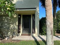 Charming front entrance featuring address numbers, dark door and shutters, and mature landscaping at 501 East Bay Dr. # 2003, Largo, FL 33770