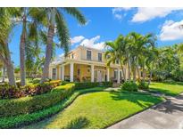 Stunning two-story home with a manicured lawn, tropical landscaping, and inviting front porch at 556 21St Ne Ave, St Petersburg, FL 33704