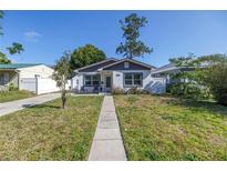 Charming single-story home with a well-manicured front yard and inviting walkway at 633 47Th N Ave, St Petersburg, FL 33703