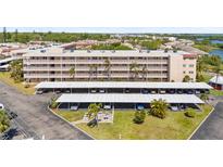 Well-maintained condo building with covered parking, lush landscaping and nearby water access at 9950 62Nd N Ter # 316, St Petersburg, FL 33708