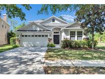 Charming single-story home with a well-manicured lawn, stone accents, and attached two-car garage at 21744 Waverly Shores Ln, Land O Lakes, FL 34637