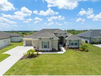 Beautiful one-story home with a well-manicured lawn and attached two-car garage at 5214 Lake Venice Dr, Wimauma, FL 33598