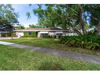 Charming single-story home with a well-manicured front yard and mature trees at 6801 5Th N St, St Petersburg, FL 33702