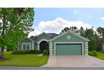 Charming single-story home with a well-manicured lawn and a two-car garage at 10118 Cleghorn Dr, San Antonio, FL 33576