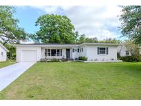 Charming single-story home with a well-manicured lawn, white exterior, and lovely curb appeal at 125 Siobhan Ave, Tampa, FL 33613