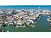 Stunning aerial view of a waterfront community with beach access and canal access at 145 174Th Terrace E Dr, Redington Shores, FL 33708