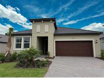 Charming single-story home featuring a two-car garage and landscaped front yard at 31753 Griffin Sands Ln, San Antonio, FL 33576
