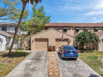 Charming townhouse featuring a two-car garage, landscaped yard, and inviting curb appeal at 4733 W Vasconia St, Tampa, FL 33629