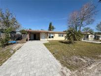 Charming single-story home with a brick driveway and a cozy covered carport at 4911 Largo Ter, New Port Richey, FL 34652