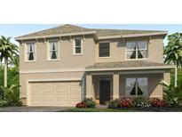 Two-story home featuring a welcoming front porch, a two car garage, and neat landscaping at 7154 Beaverhead Ln, Land O Lakes, FL 34638