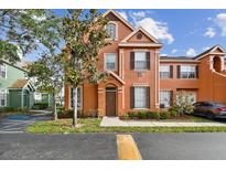 Charming townhouse featuring a well-maintained lawn and manicured bushes, creating a welcoming curb appeal at 9740 Lake Chase Island Way # 9740, Tampa, FL 33626