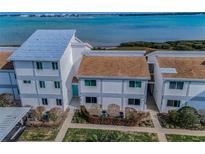 Well-maintained townhouses with manicured lawns and landscaping offer a serene and inviting curb appeal at 1451 Gulf Blvd # 207, Clearwater Beach, FL 33767