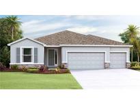 Charming single-story home featuring a stone-accented facade, a three-car garage, and well-manicured landscaping at 19657 Gladeview Way, Land O Lakes, FL 34638