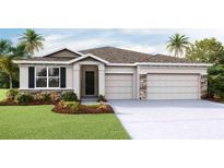 Inviting single-story home featuring a covered entryway, a stone-accented garage, and lush landscaping at 19669 Gladeview Way, Land O Lakes, FL 34638