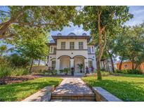 Charming two-story home featuring a beautifully landscaped front yard with a welcoming walkway at 7120 3Rd N Ave, St Petersburg, FL 33710