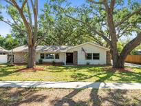 Charming single-story home with lush landscaping and mature trees in a desirable neighborhood at 13556 Lake Magdalene Dr, Tampa, FL 33613