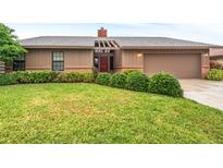 Charming single-story home with beautiful landscaping and a well-manicured green lawn at 1916 38Th W St, Bradenton, FL 34205