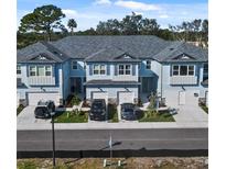 Charming townhomes featuring a blue exterior, attached garages, and well-maintained landscaping in a desirable community at 7765 93Rd N St, Seminole, FL 33777
