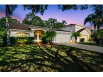 Charming single-story home featuring lush landscaping and a well-maintained lawn at 12929 Royal George Ave, Odessa, FL 33556