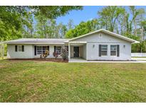 Charming single-story home featuring a well-maintained lawn and inviting front entrance at 346 Ranch Rd, Tarpon Springs, FL 34688