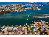 Aerial view of waterfront homes with docks and boat lifts on canal leading to the Gulf of Mexico at 366 La Hacienda Dr, Indian Rocks Beach, FL 33785