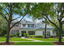 Charming two-story home with stone accents, lush landscaping, and a well-manicured lawn at 5806 Terncrest Dr, Lithia, FL 33547