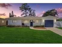 Charming single-story home with a well-manicured lawn and a fresh exterior paint job at 9100 2Nd N St, St Petersburg, FL 33702