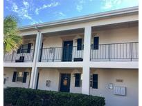 Clean two-story exterior featuring front porches and a well-maintained landscape with shrubbery at 10316 Carrollwood Ct # 57, Tampa, FL 33618