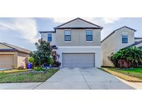 Charming two-story home with a well-maintained lawn and a two-car garage at 13923 Arbor Pines Dr, Riverview, FL 33579