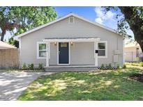 Charming single-story home featuring a well-maintained front lawn and inviting entrance at 2415 E 20Th Ave, Tampa, FL 33605