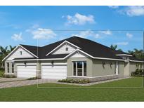 Lovely one-story home with a three car garage, neutral exterior, and well-maintained lawn at 2836 Marrakesh Ln, Sarasota, FL 34234