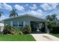 Charming single-story home featuring mature landscaping and a covered carport at 4551 Floramar Ter, New Port Richey, FL 34652