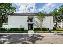 Two-story white condominium complex featuring well-maintained landscaping and easy access to units at 801 Russell Ln # 255, Brandon, FL 33510