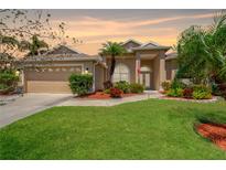 Charming home with a well-manicured lawn, a two car garage, and mature landscaping at 8902 30Th E St, Parrish, FL 34219