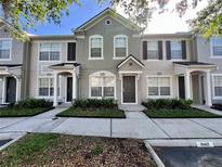 Charming townhome featuring well-maintained landscaping and neutral-toned exterior at 10407 Westpark Preserve Blvd, Tampa, FL 33625