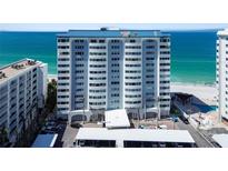 Beautiful exterior view of the beachfront condo building with light blue trim and stunning ocean views at 1750 Benjamin Franklin Dr # 11G, Sarasota, FL 34236