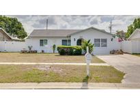 Charming single-story home with manicured landscaping and a well-maintained front yard at 2605 Fulton Sw St, Largo, FL 33774