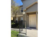 Inviting condo exterior with neutral paint, welcoming front door and small decorative garden at 5904 Willow Ridge Dr # 202, Zephyrhills, FL 33541