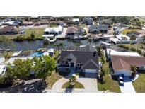 Stunning aerial view of a waterfront home with a private canal and boat dock at 6505 Bimini Ct, Apollo Beach, FL 33572