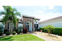 Beautiful home exterior featuring a well-manicured lawn, lush landscaping, and a striking stone facade at 16612 5Th E Ave, Bradenton, FL 34212