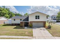 Charming two-story home features a brick facade, attached garage, and well-manicured lawn at 206 Soldier Ct, Seffner, FL 33584