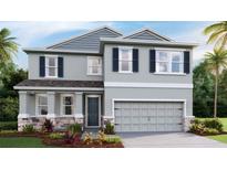 Two-story home with gray siding, dark shutters, stone accents, and a two-car garage at 3316 Amber Waves Dr, Plant City, FL 33565