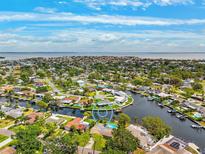 Stunning aerial view of waterfront homes with lush landscaping and private docks on a sunny day at 5201 Dover Ne St, St Petersburg, FL 33703
