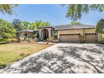 Stunning home features a three-car garage and beautifully landscaped front yard at 15810 Stanton Ln, Tampa, FL 33647